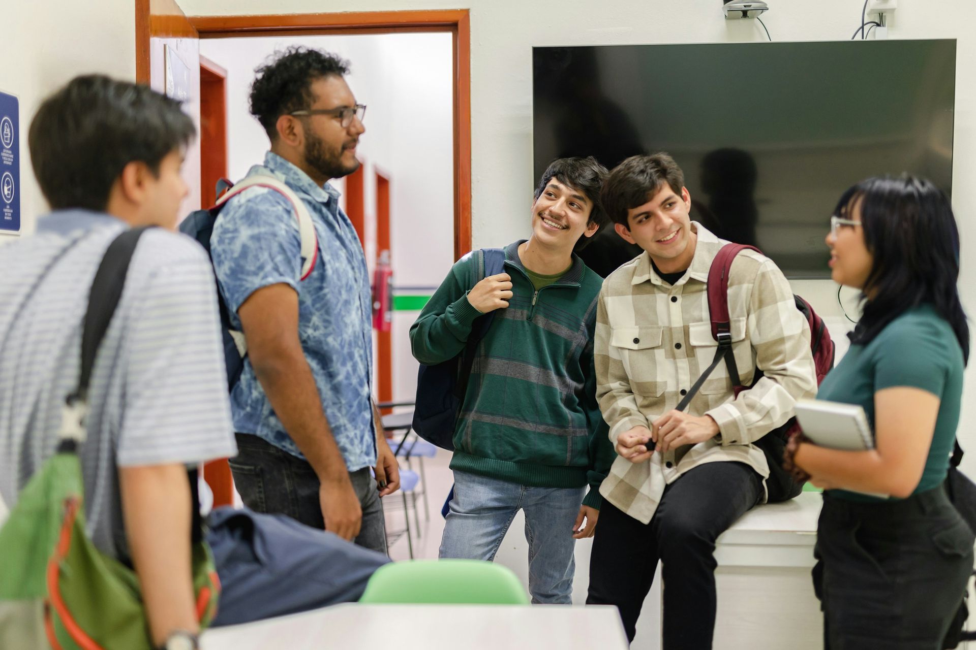 Group of diverse students engaged in a discussion – reflecting collaborative learning at UniHouse