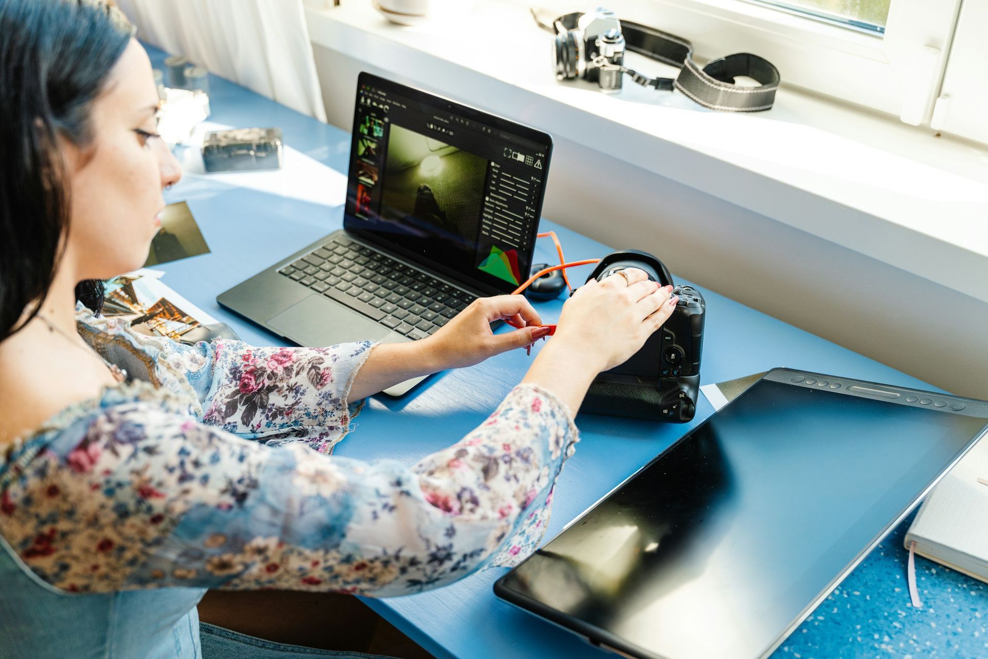 Woman working remotely with laptop and camera — digital skills and gig economy, UniHouse WEE™