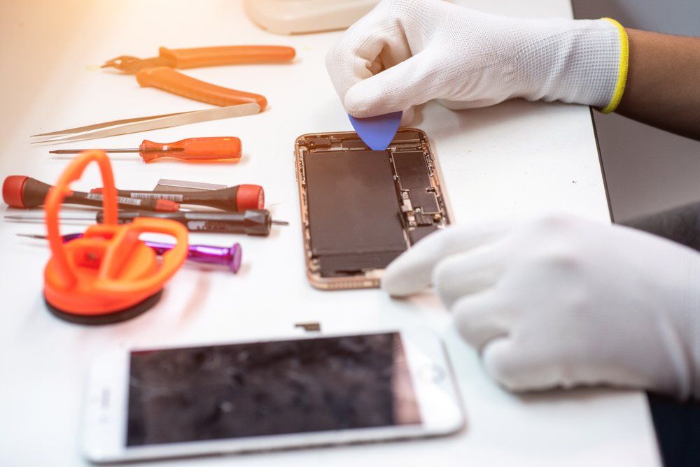 Male Technician Change The Battery Smartphone — Efficient iPhone Repairs in Ballina, NSW