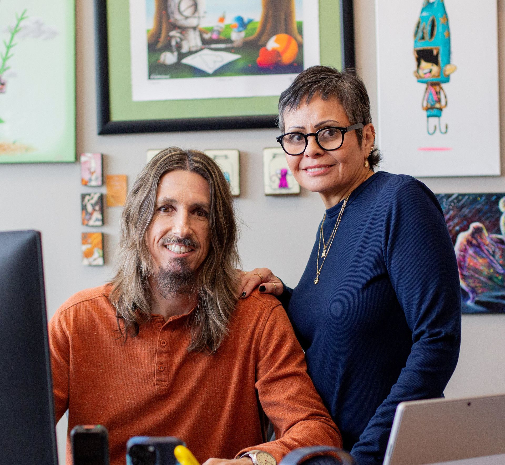 Brian and Julissa smiling in their office. 