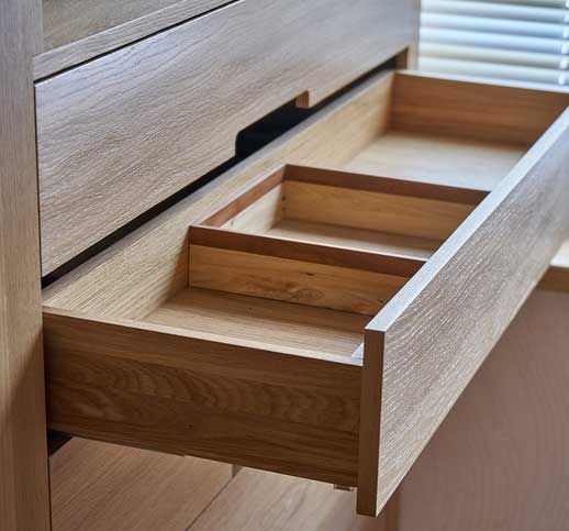Wooden cupboard with opened drawer