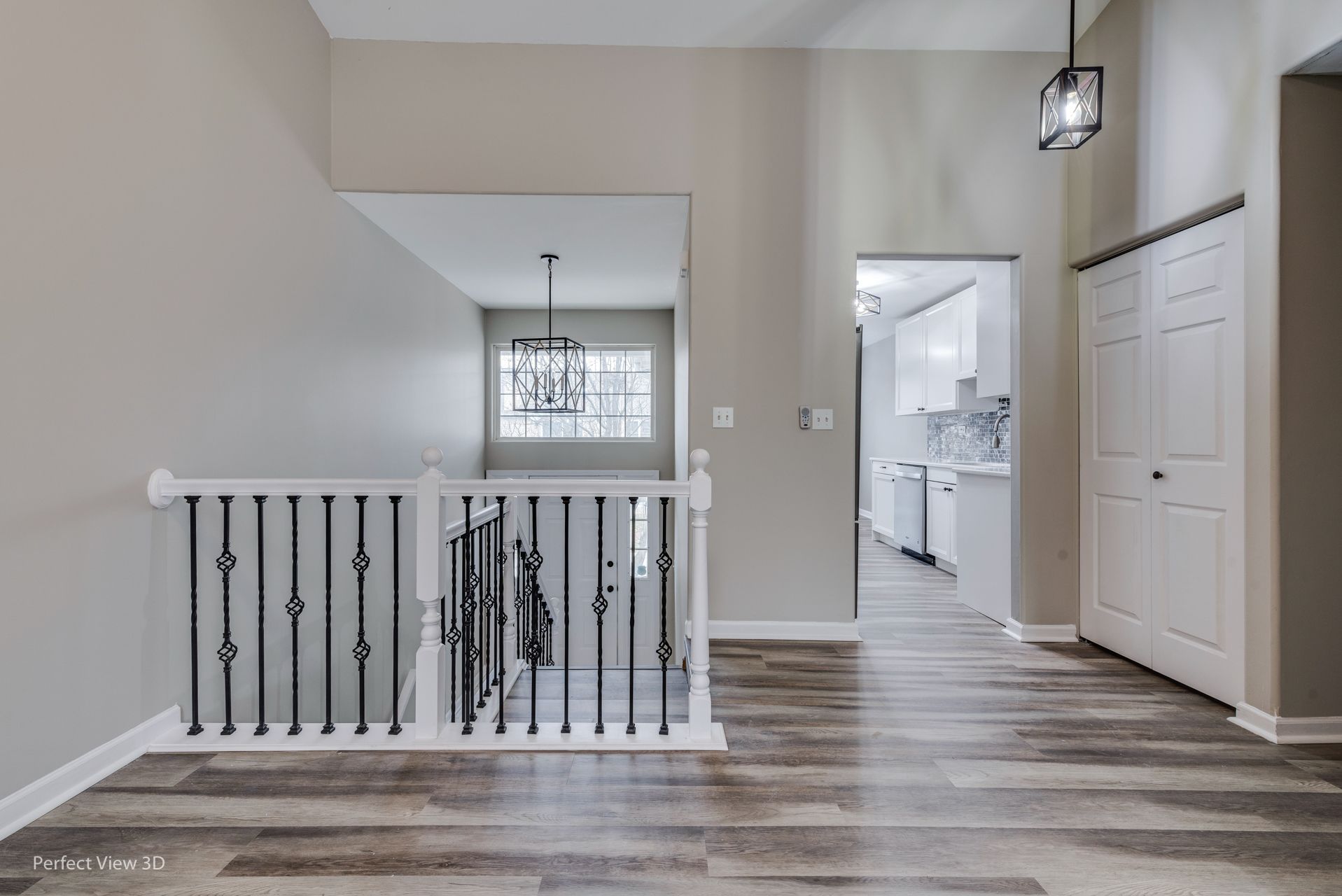 A hallway with a staircase leading up to the second floor of a house.