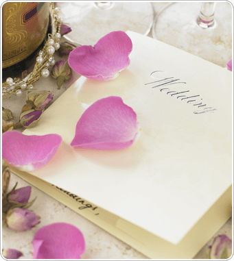 fancy wedding invitation covered in ribbons
