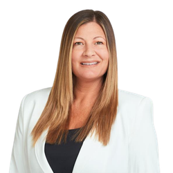 Portrait of Nicole Bennetsen in a white blazer over a black top on a white background