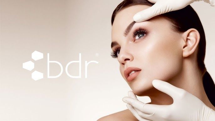 Woman's face with hands in gloves touching it;