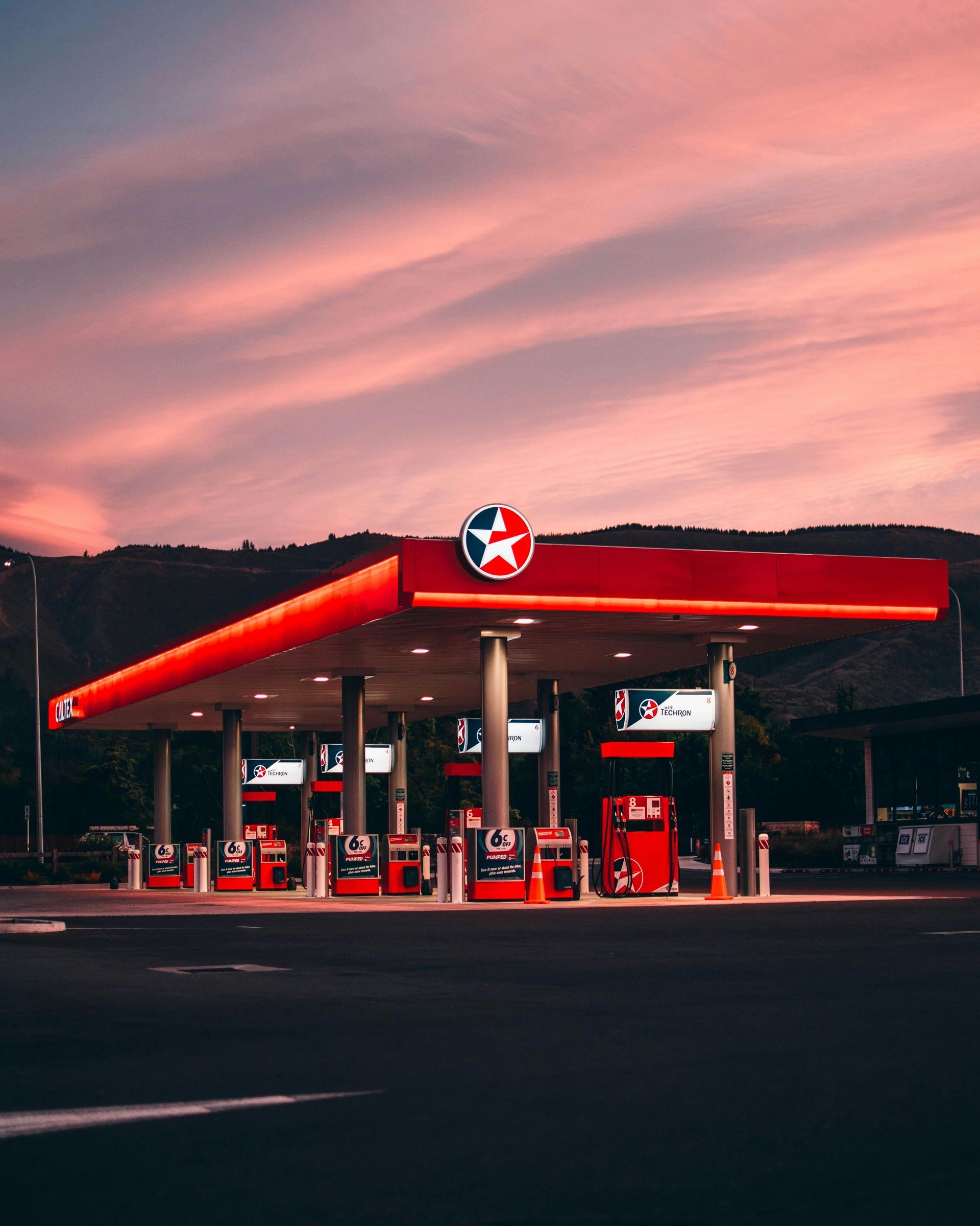 A red gas station with a star on the top of it