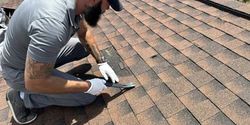 A man is kneeling on a roof holding a spatula. A man is kneeling on a roof holding a spatula.