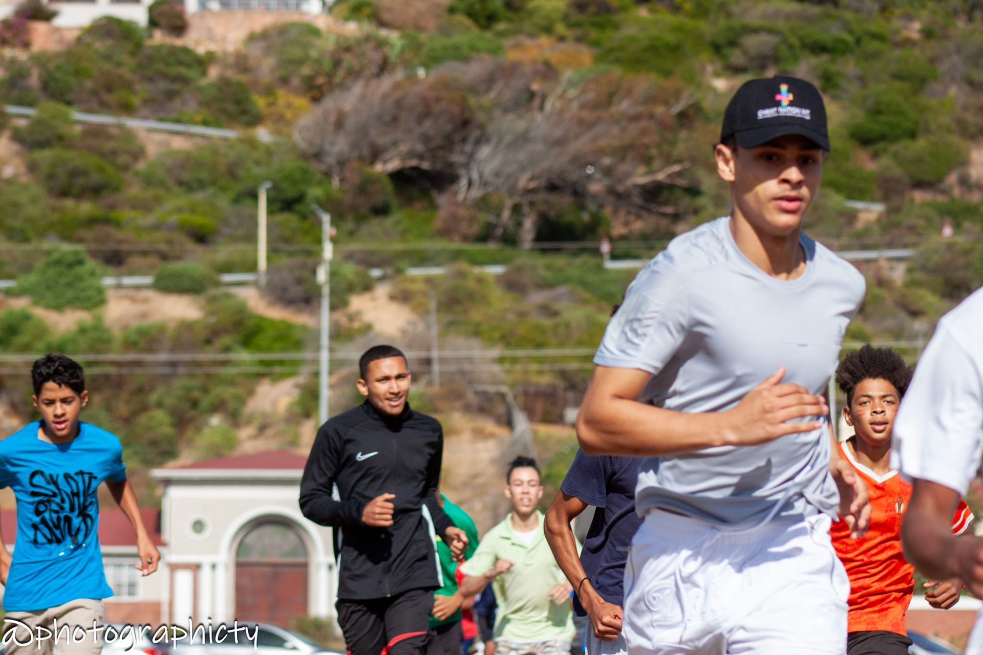 a woman standing in front of a chalkboard that says muiz kitchen