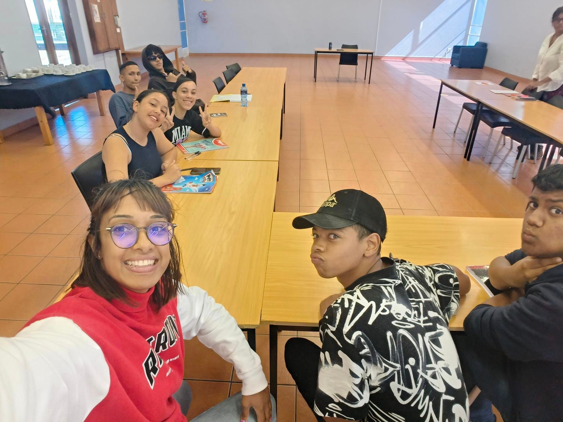 a man and a woman are peeling potatoes in a blue bowl .