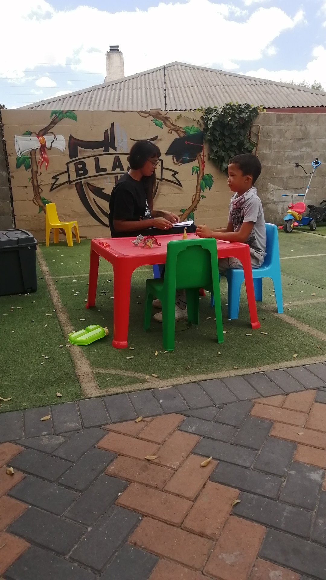a man is sitting at a table with two children .