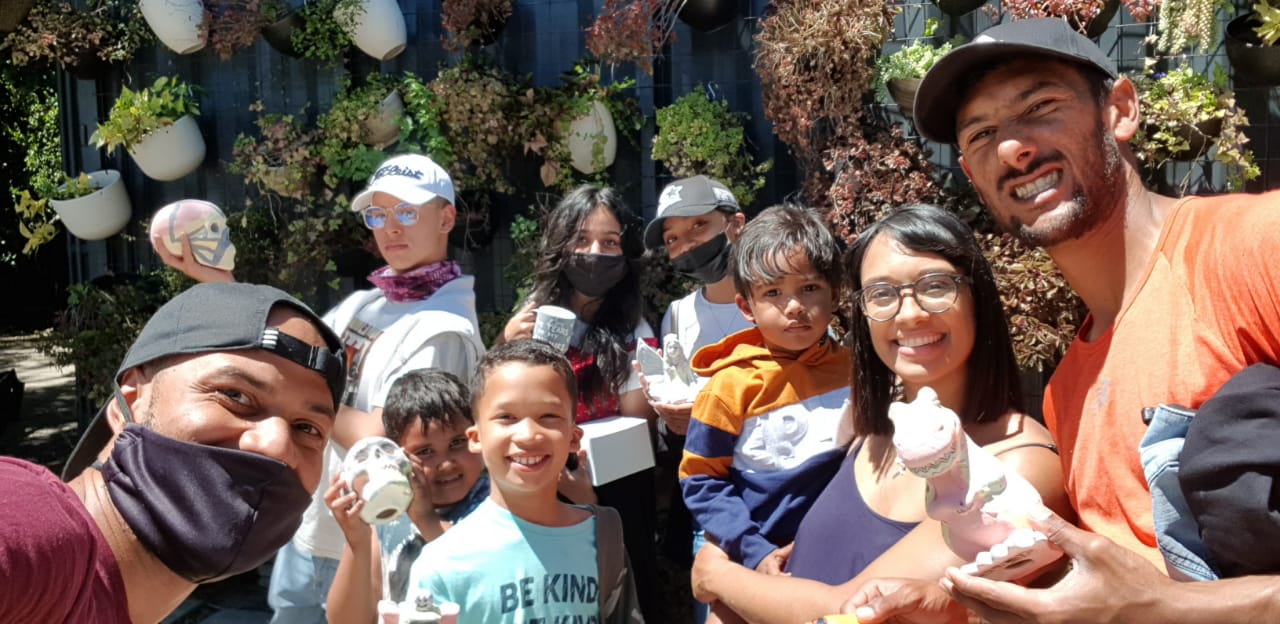 a group of people wearing face masks are posing for a picture .