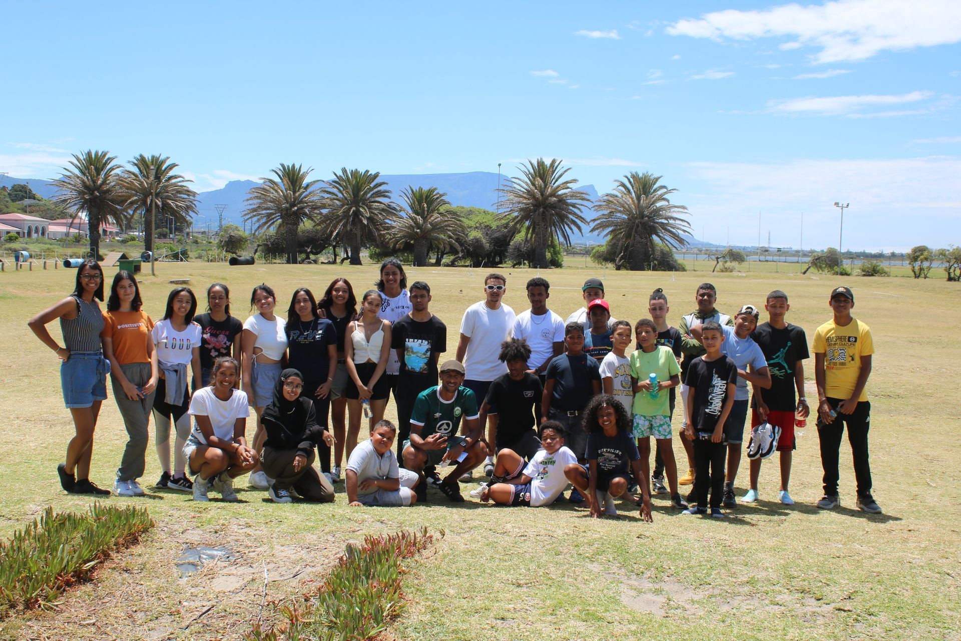 a group of people are posing for a picture in a field .