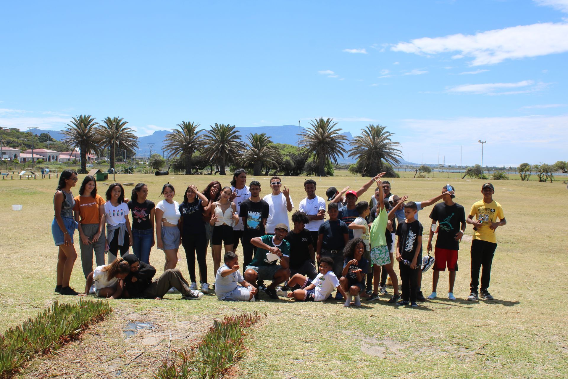 a group of people are posing for a picture in a field .