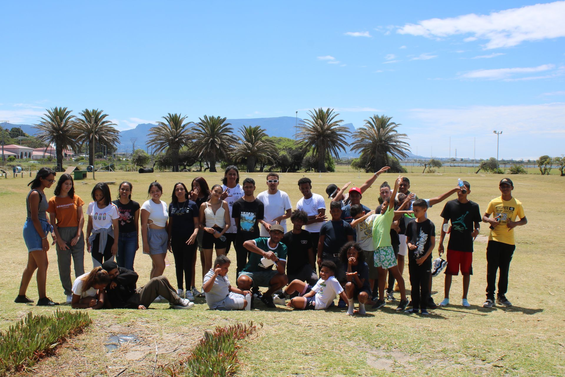 a group of people are posing for a picture in a field .