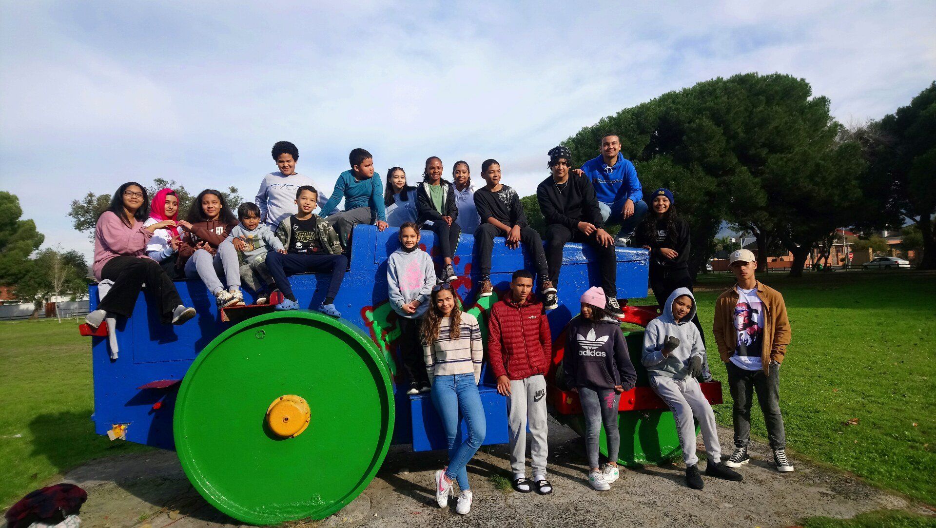a group of people are posing for a picture in front of a tractor .