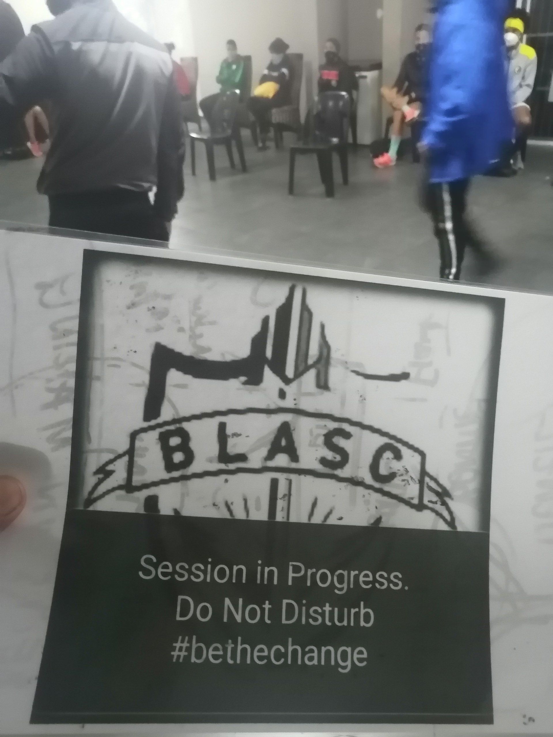a sign that says blasc session in progress do not disturb #bethechange