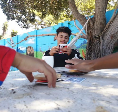 a man holding a card that says ' i ' on it