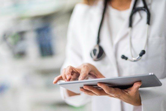 Doctor using iPad — Tampa, FL — North Tampa Foot Care