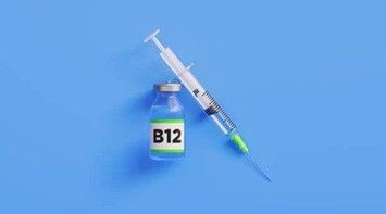 Vial labeled B12 next to a syringe on a blue background.