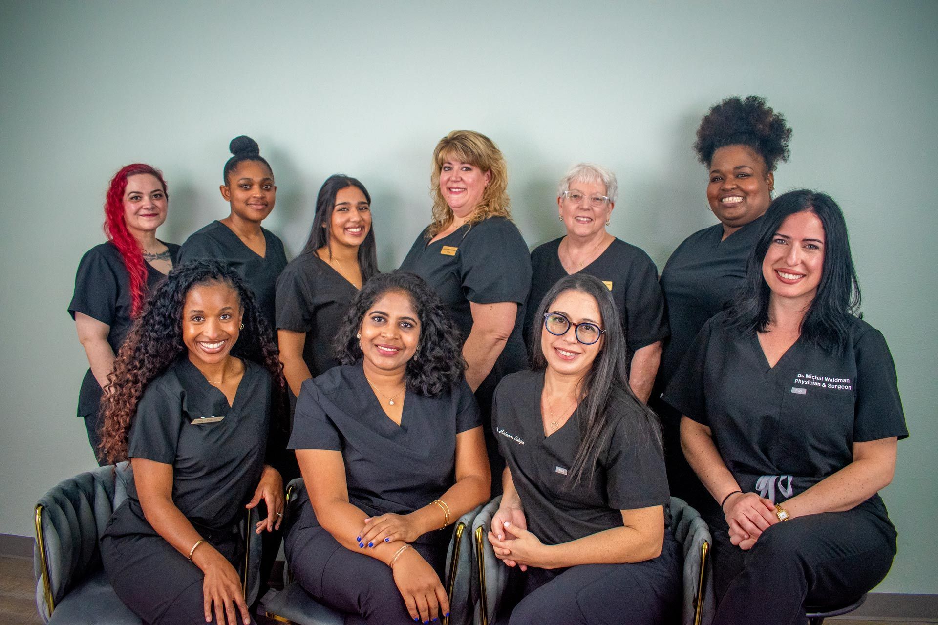 A group of women in scrubs are posing for a picture.