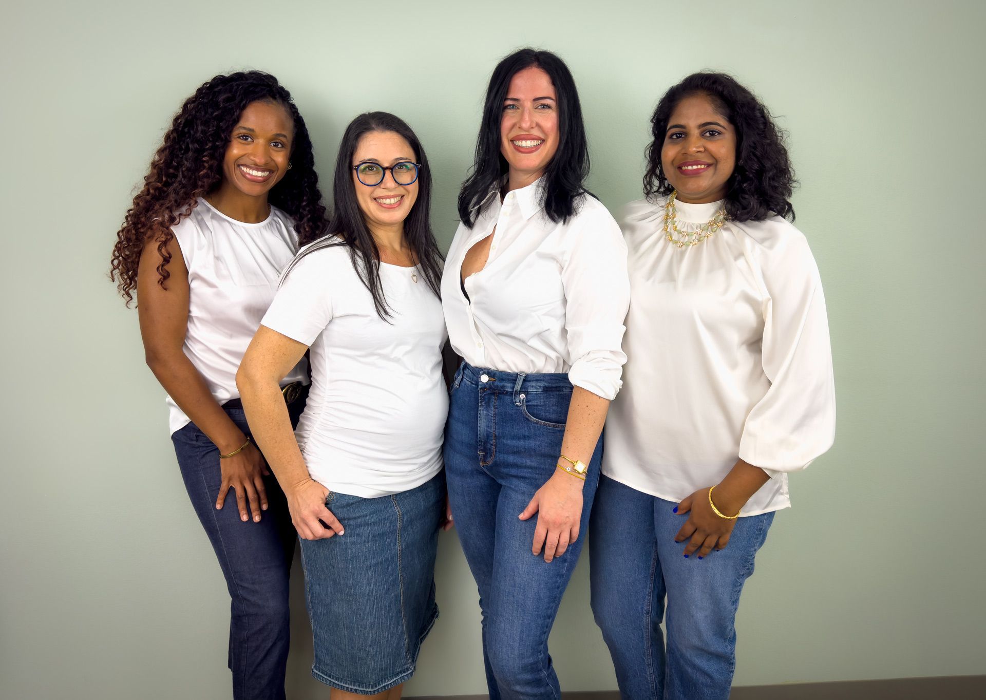 A group of women are posing for a picture together.