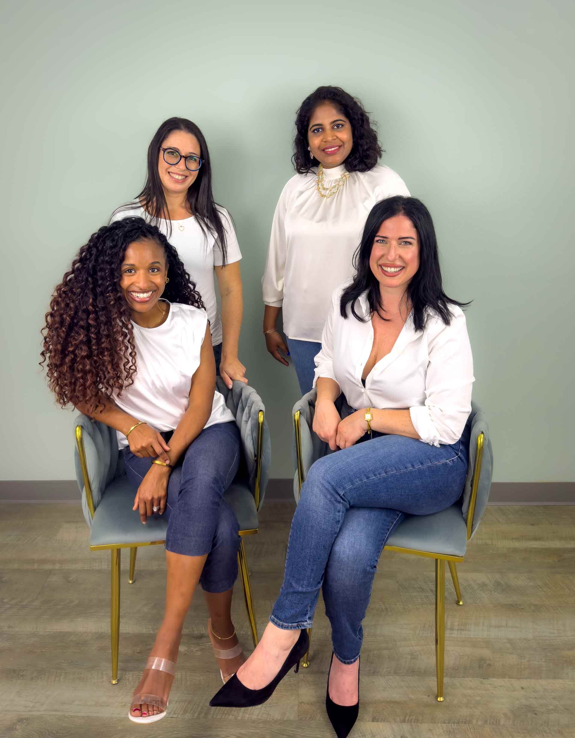 A group of women are posing for a picture together.