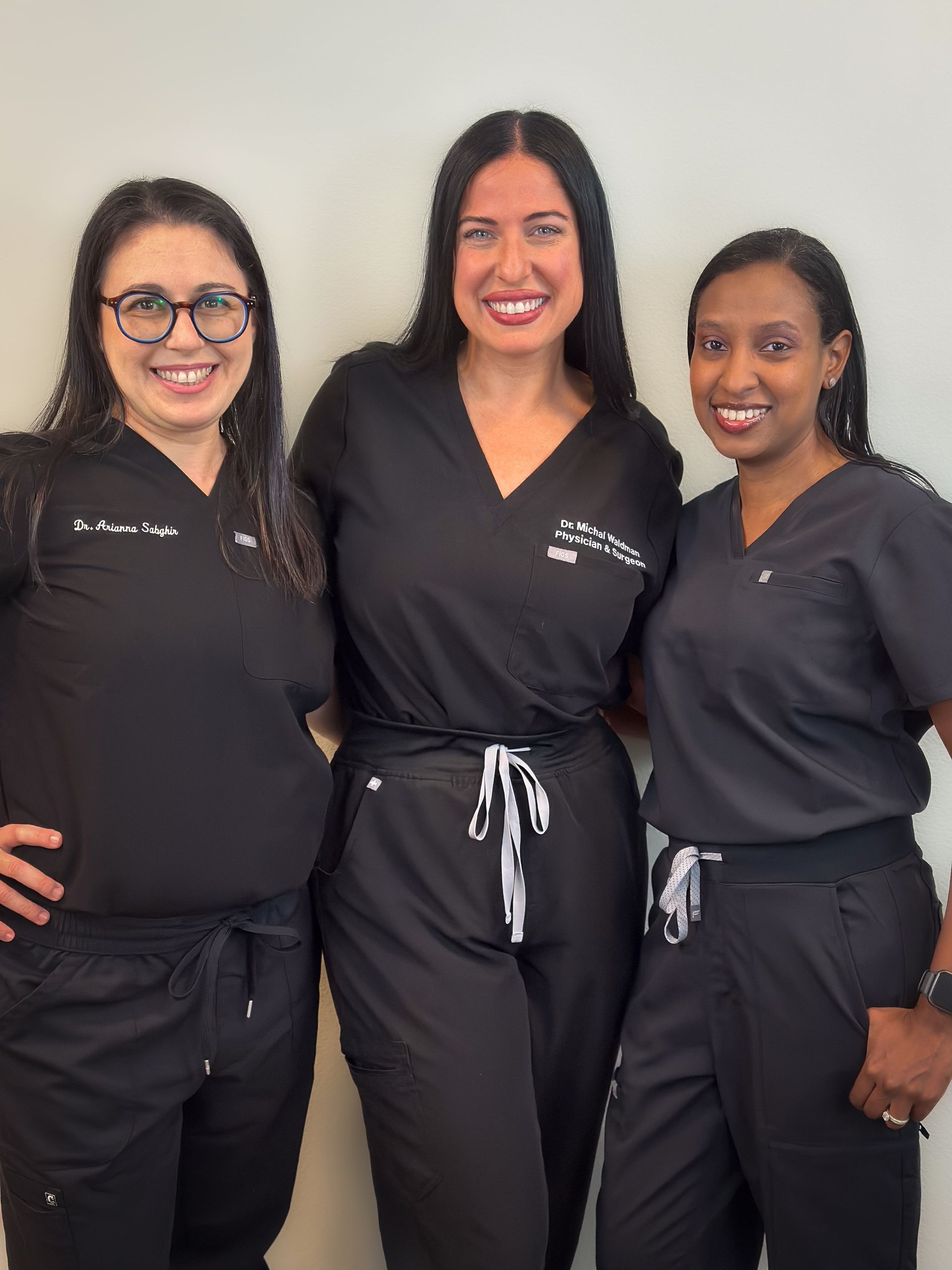 A group of women are posing for a picture together.