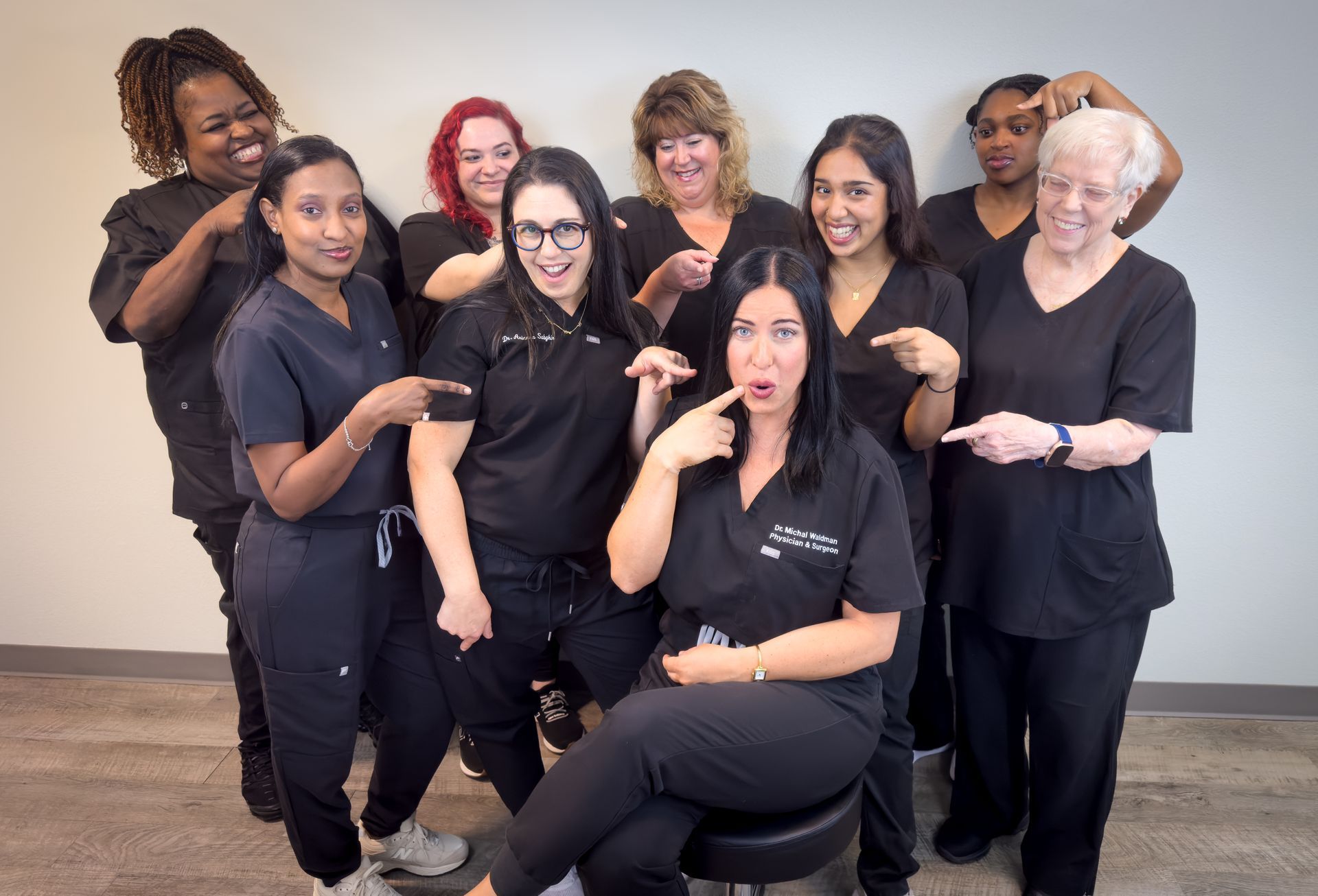 A group of women in scrubs are posing for a picture.