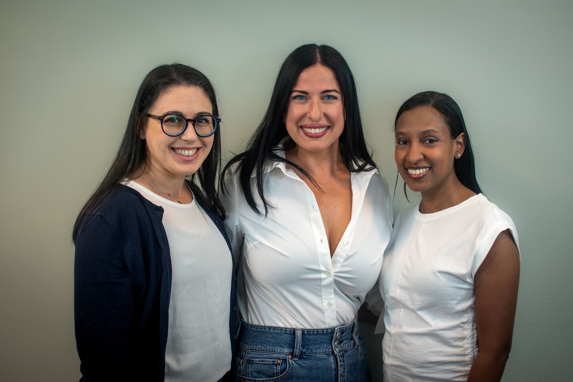 A group of women are posing for a picture together.