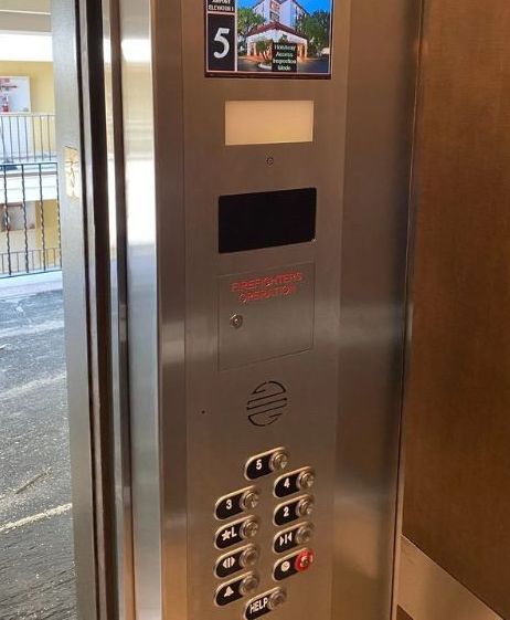 technician worker adjusting elevator mechanism