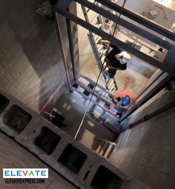 technician worker adjusting elevator mechanism