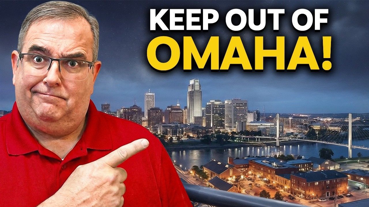A person in a red shirt points toward a city skyline at night with the text 