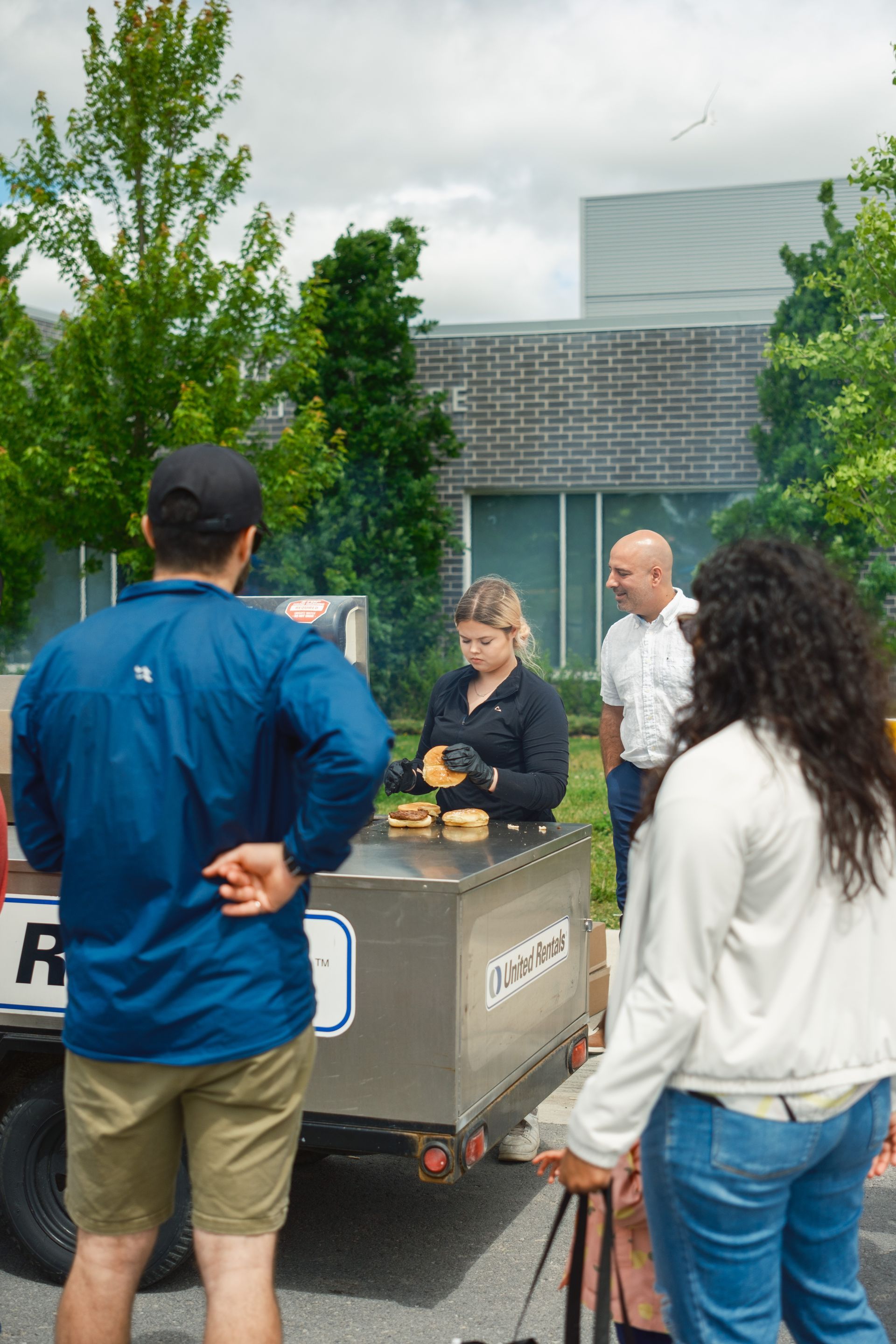 A group of people are standing around a food truck.
