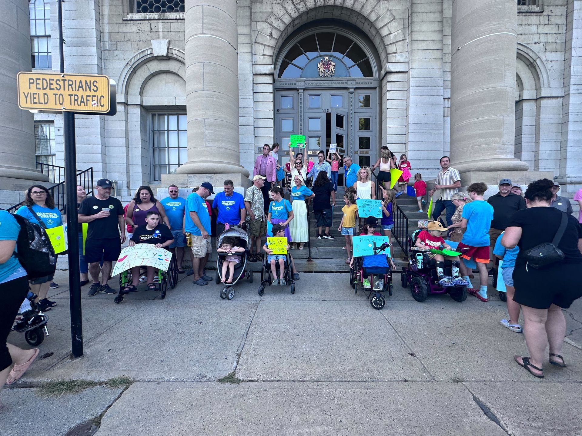A group of people standing in front of a building with a sign that says pedestrians field to traffic