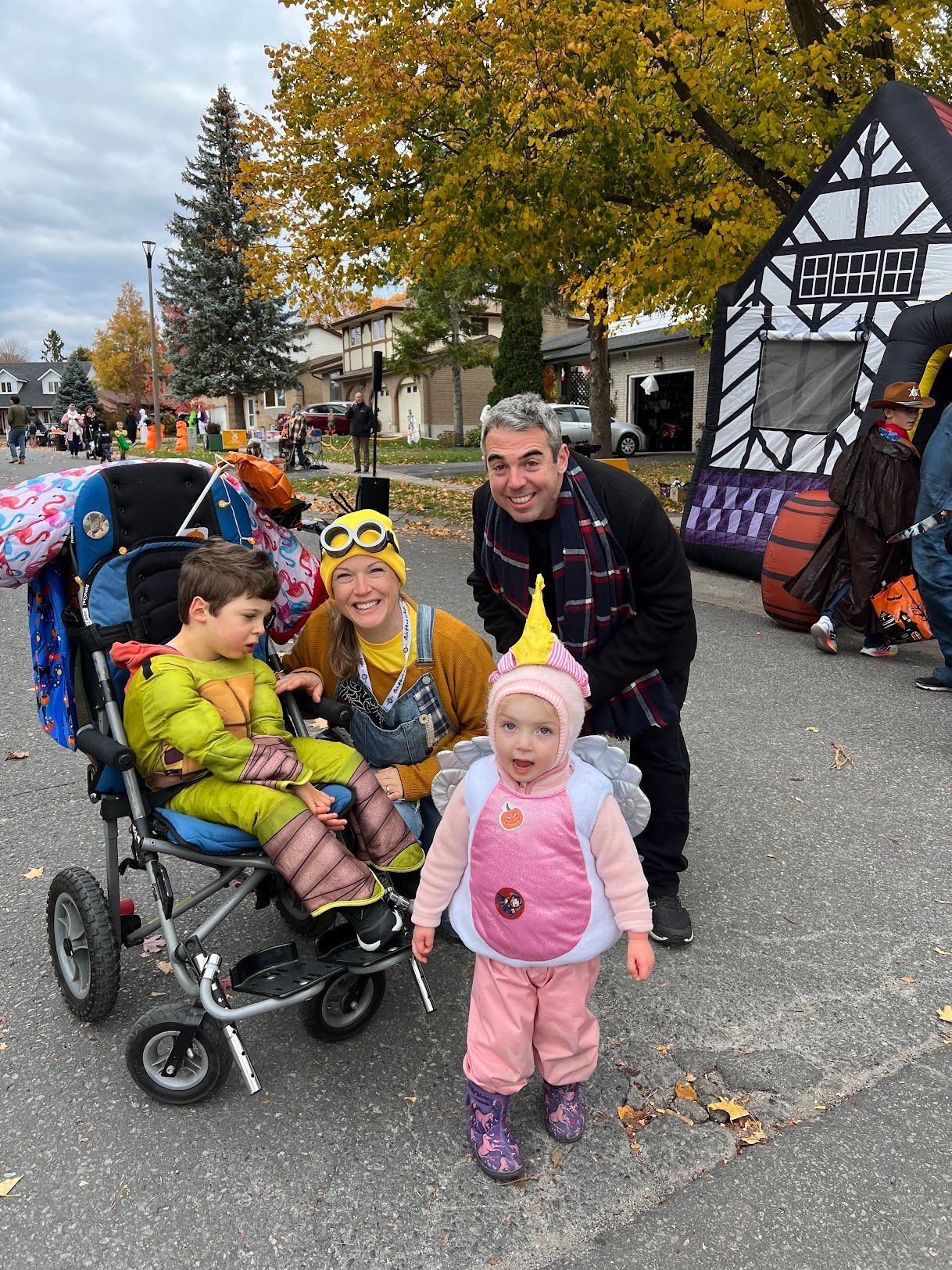 A group of people are standing next to each other on a street.