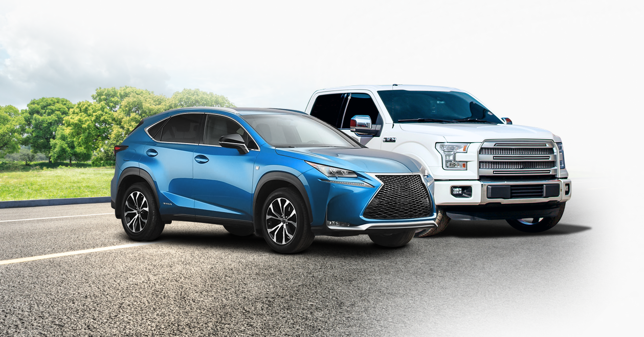 A blue car and a white truck are parked on the side of a road. | Parkway Automotive