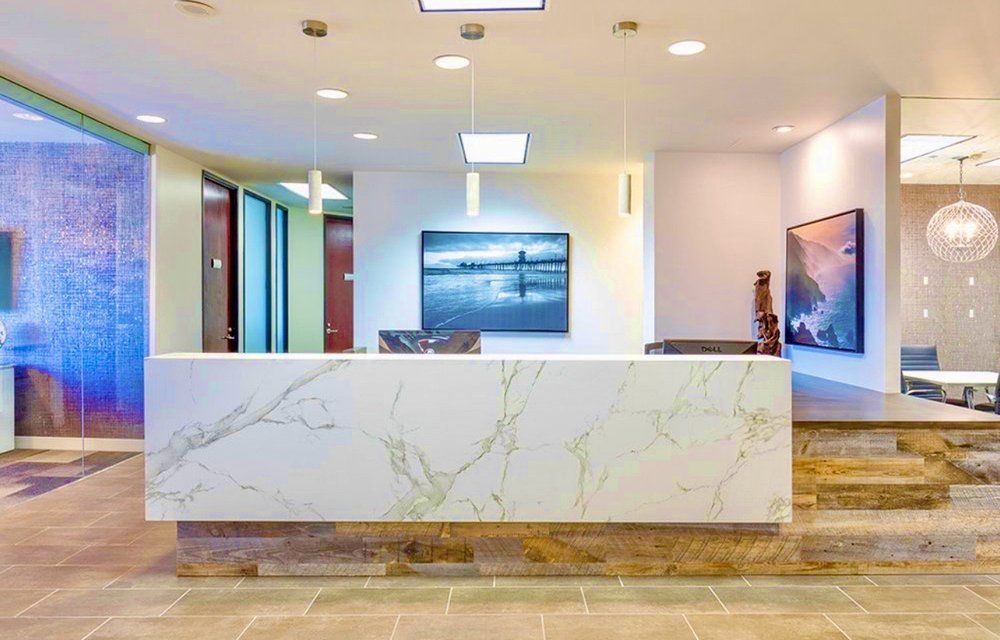 There is a large white counter in the middle of the room.