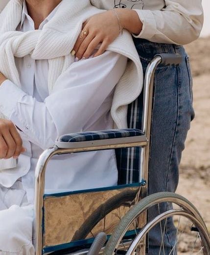 an older man is hugging a younger woman