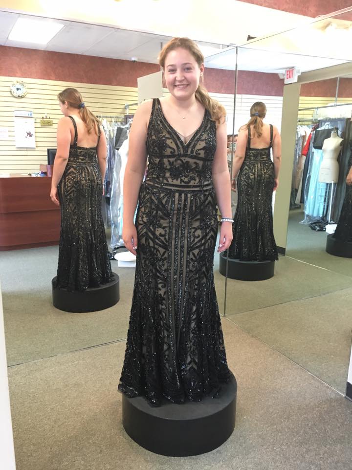 Girl wearing black embodied prom dress