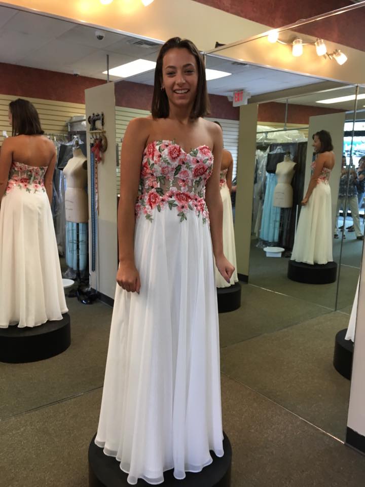 Girl wearing white floral embodied prom dress