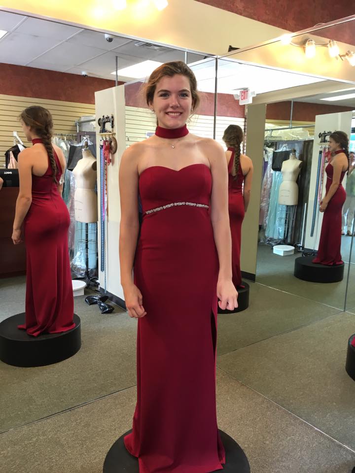 Girl wearing off shoulder wine colored sheath gown