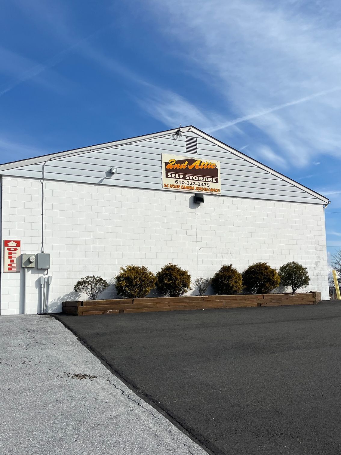 A large white building with a sign on the side that says ' land of hills '