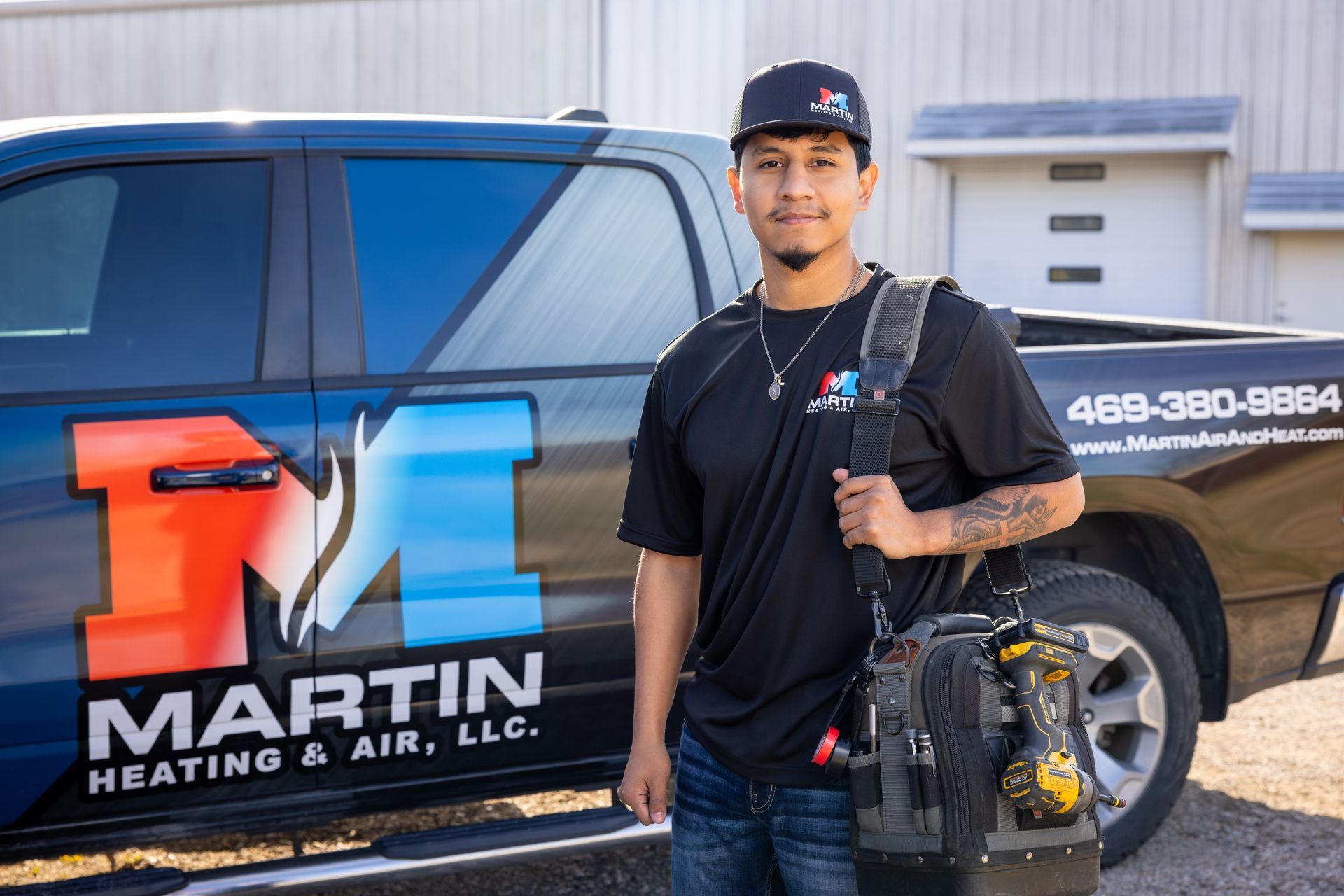Two air conditioners are sitting on the side of a house.