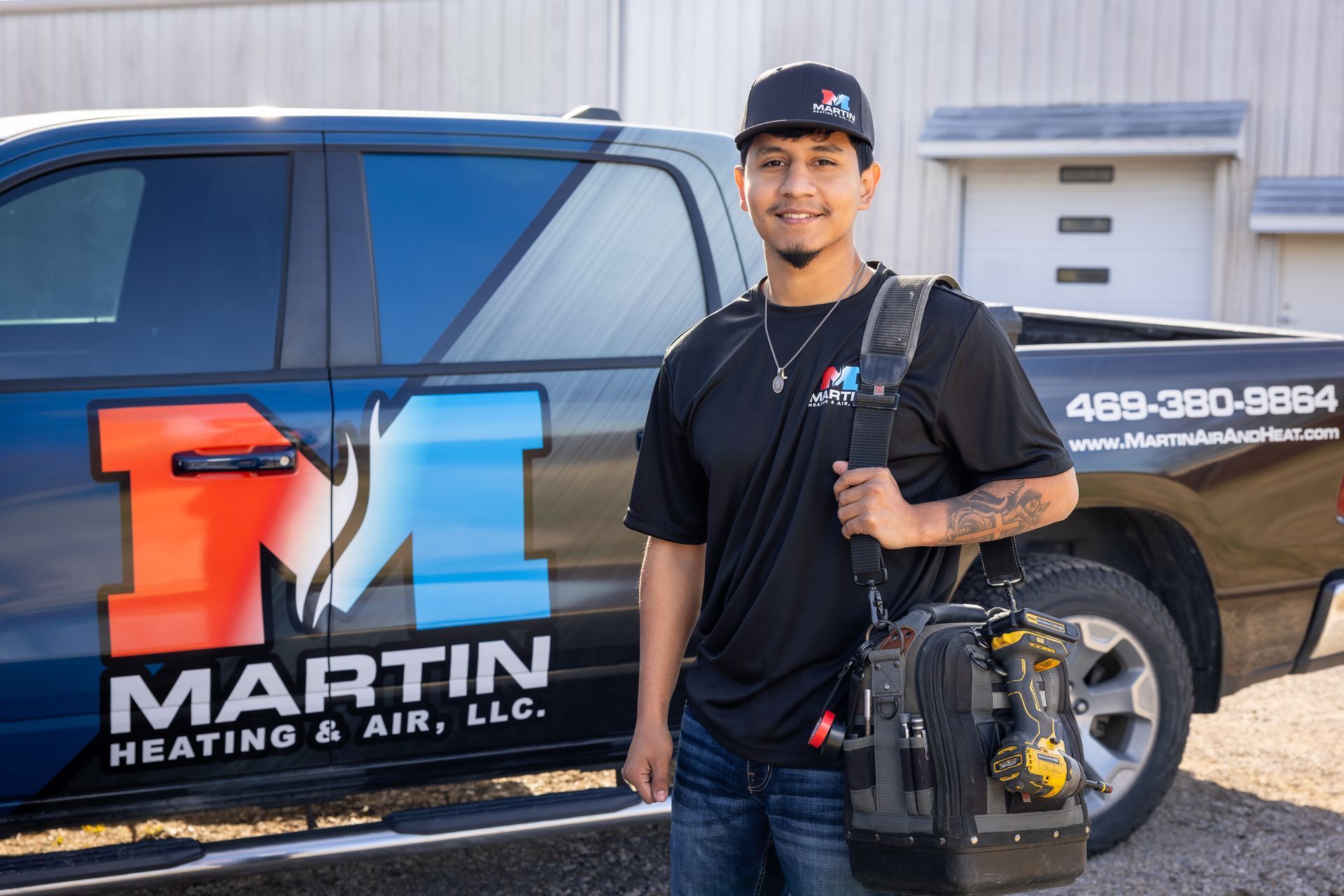 Two men are working on an air conditioner outside of a building.