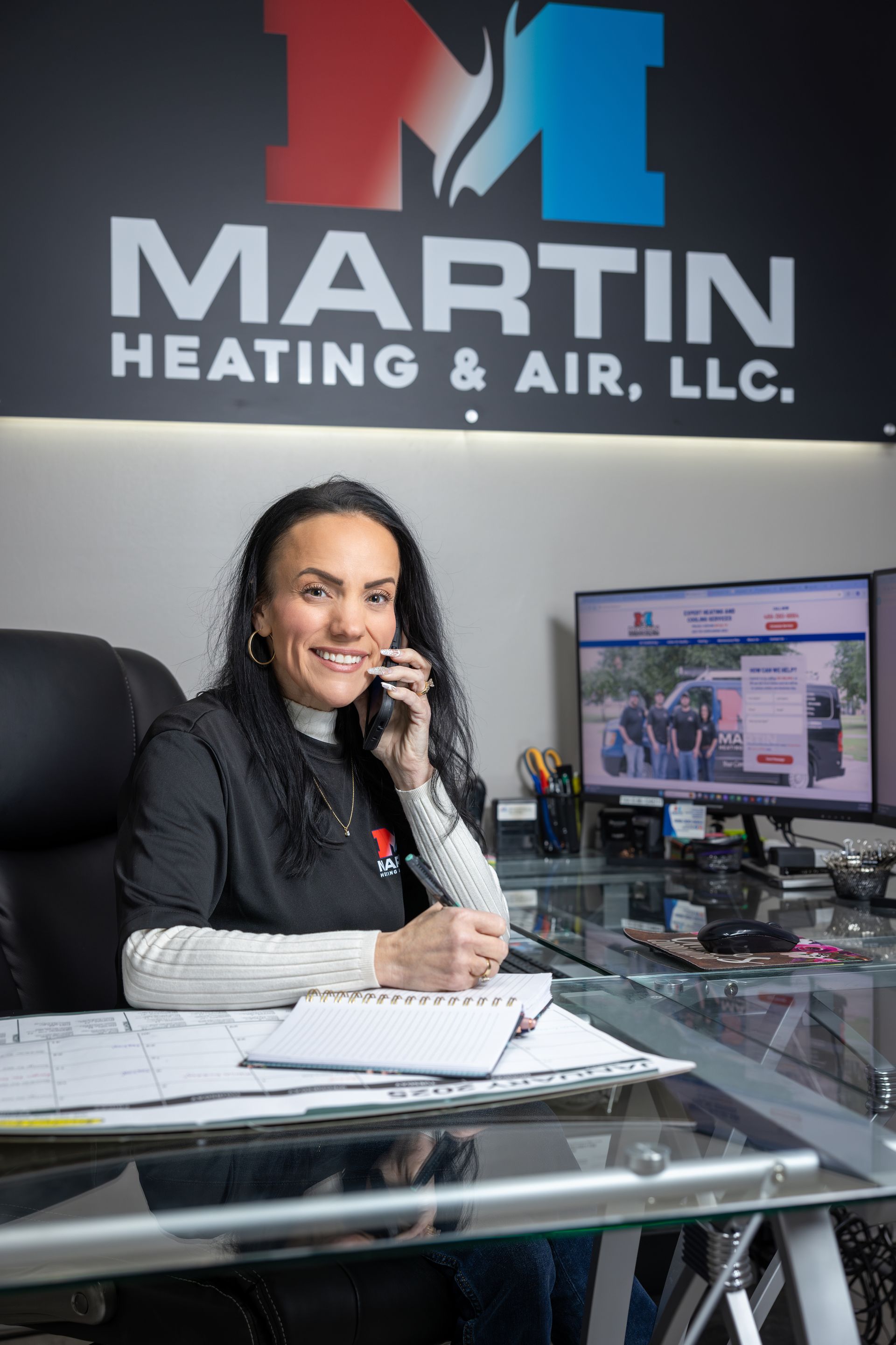 A man and a woman are sitting on a couch looking at a tablet.