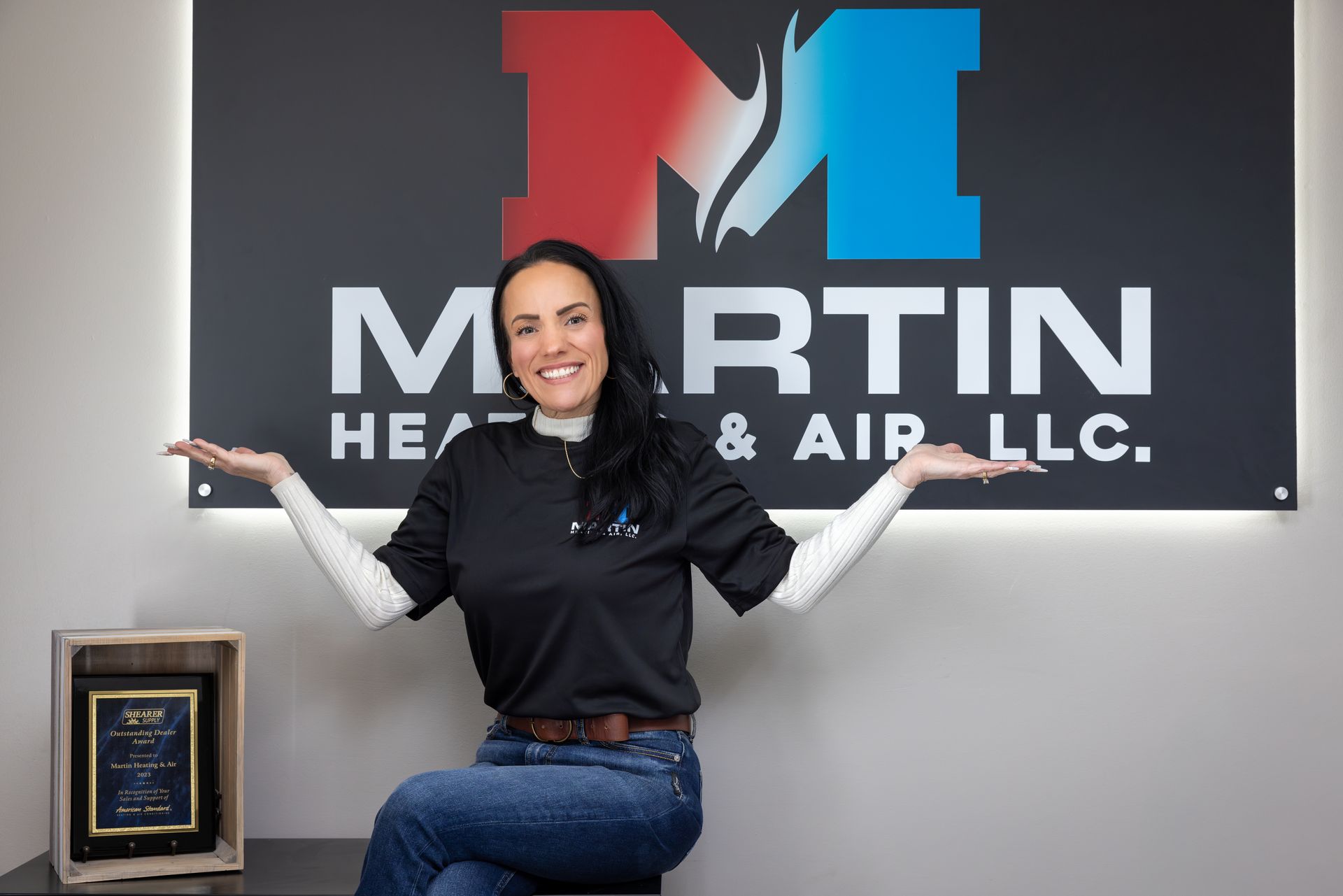 A woman is adjusting a light switch in a living room.