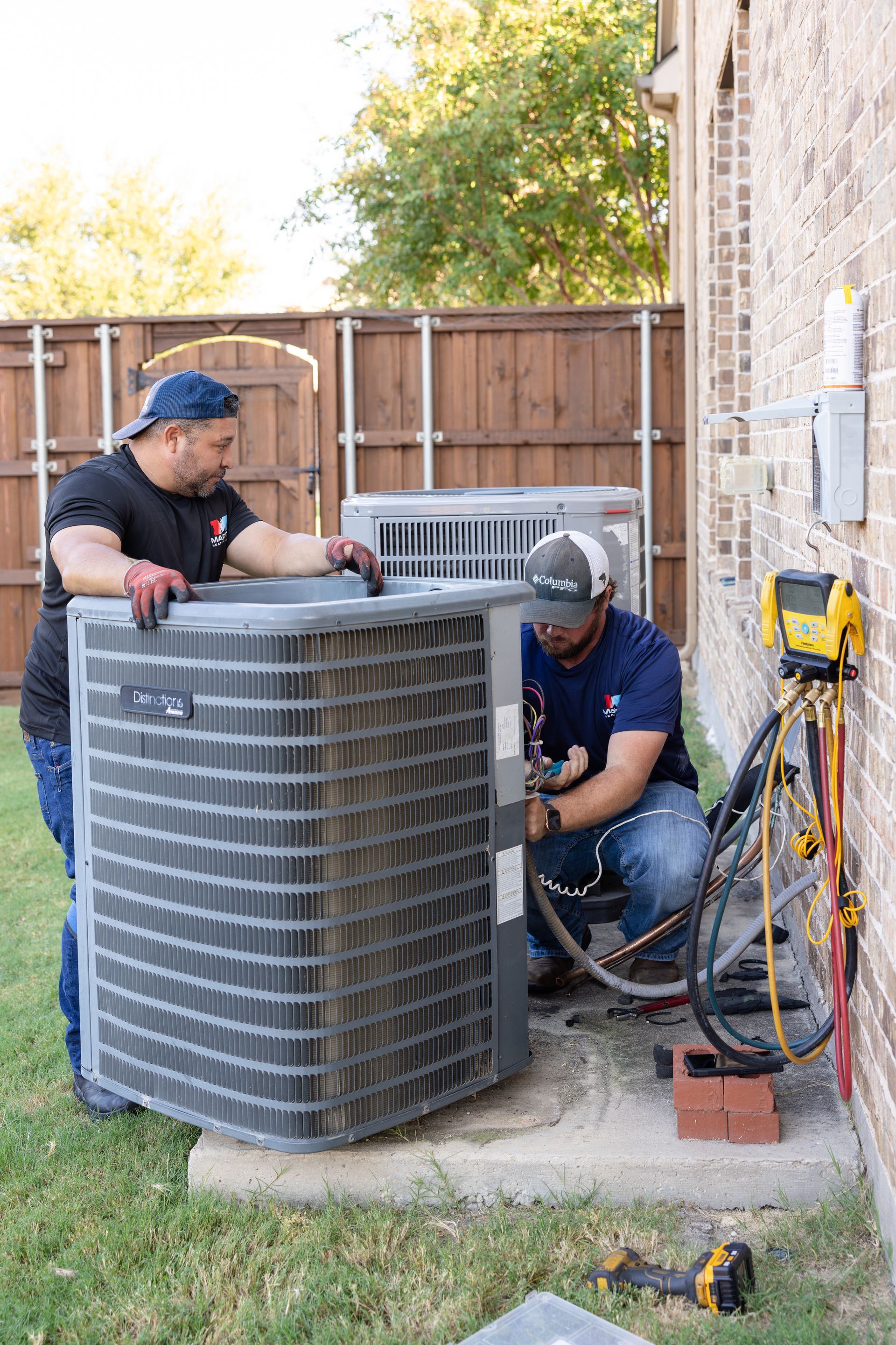 A family is sitting on a couch with a laptop.