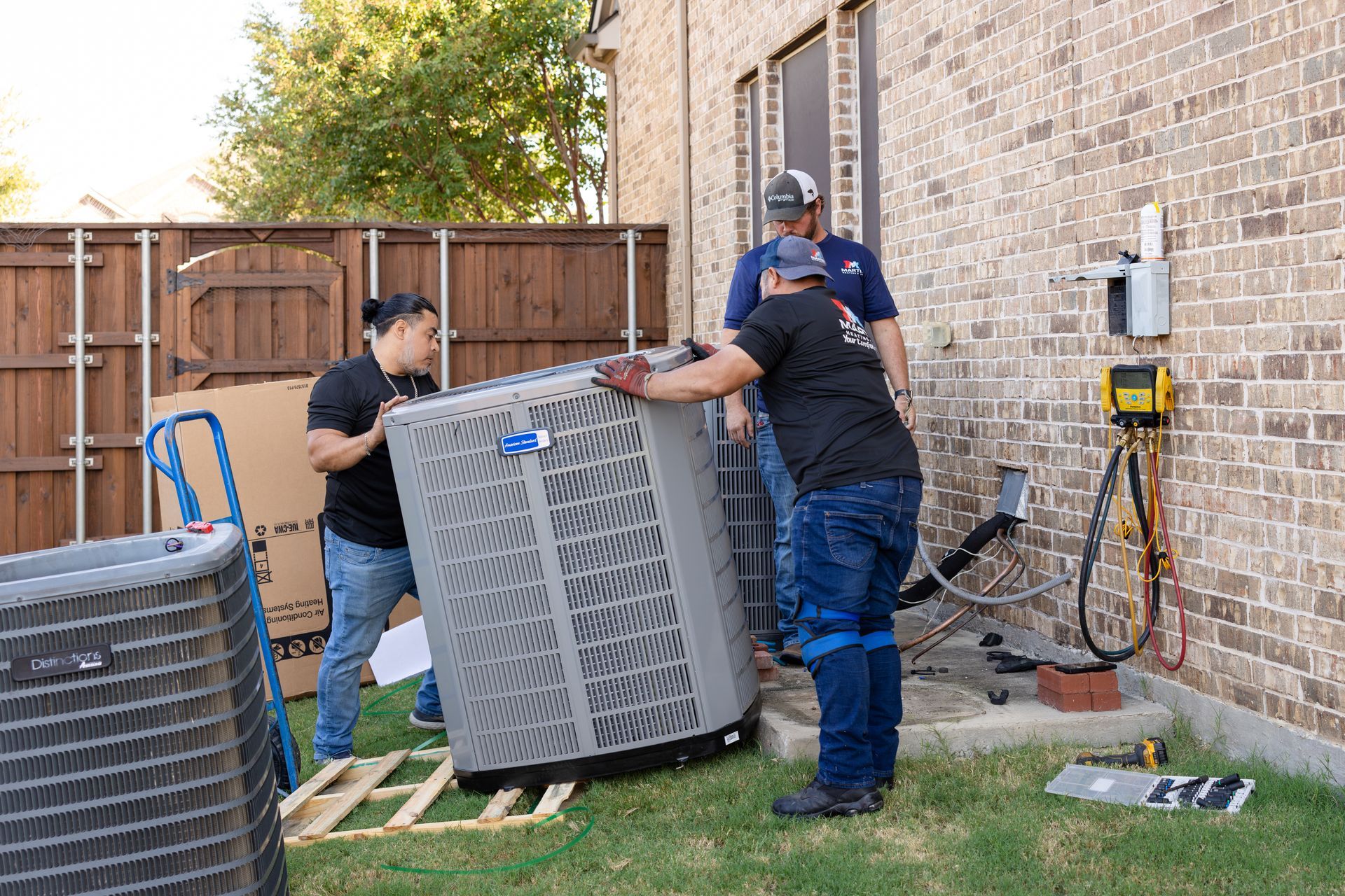 A family is sitting on a couch in a living room while two children are playing on the floor.