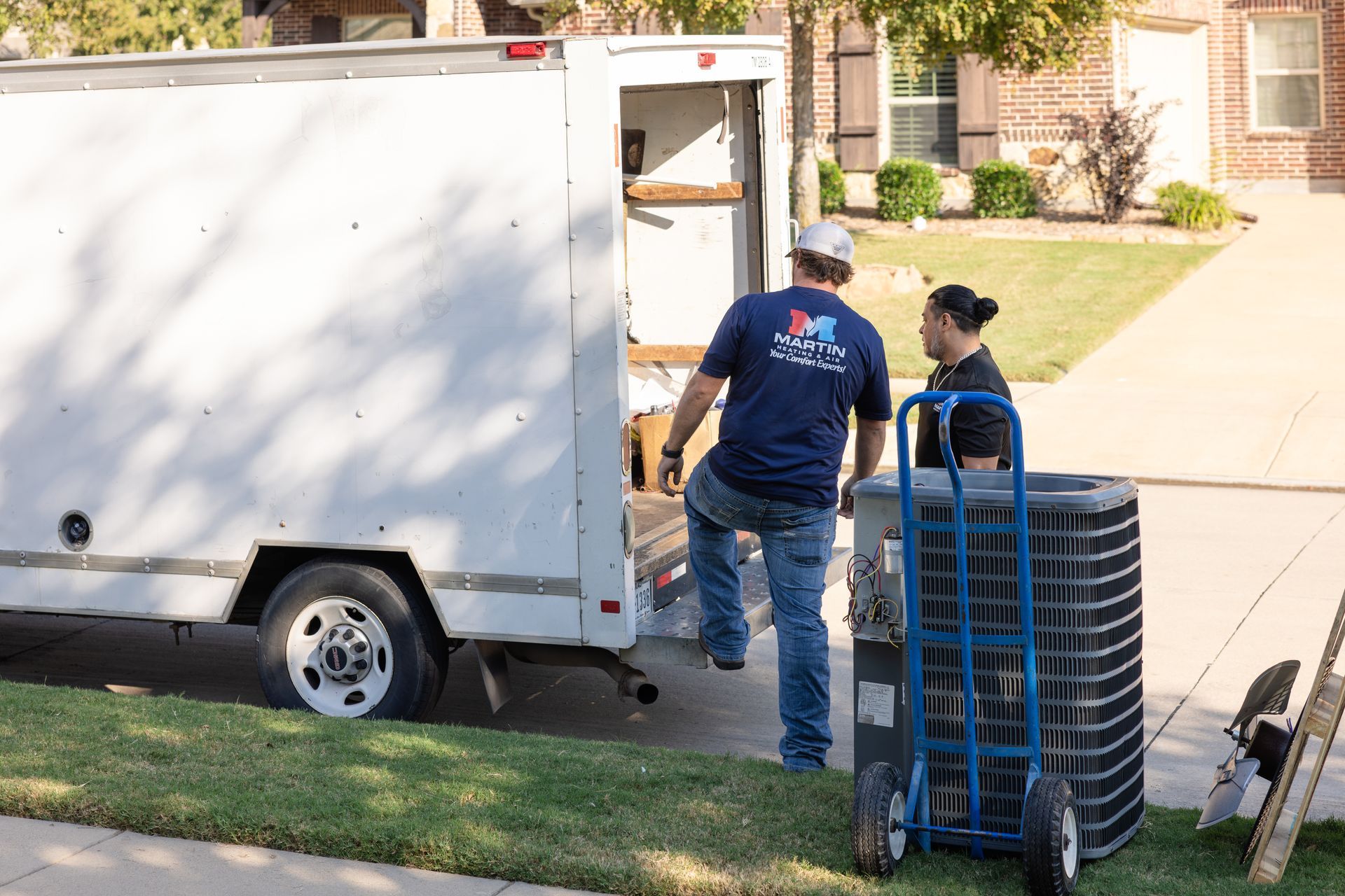 A woman and a child are sitting on a window sill looking out the window.