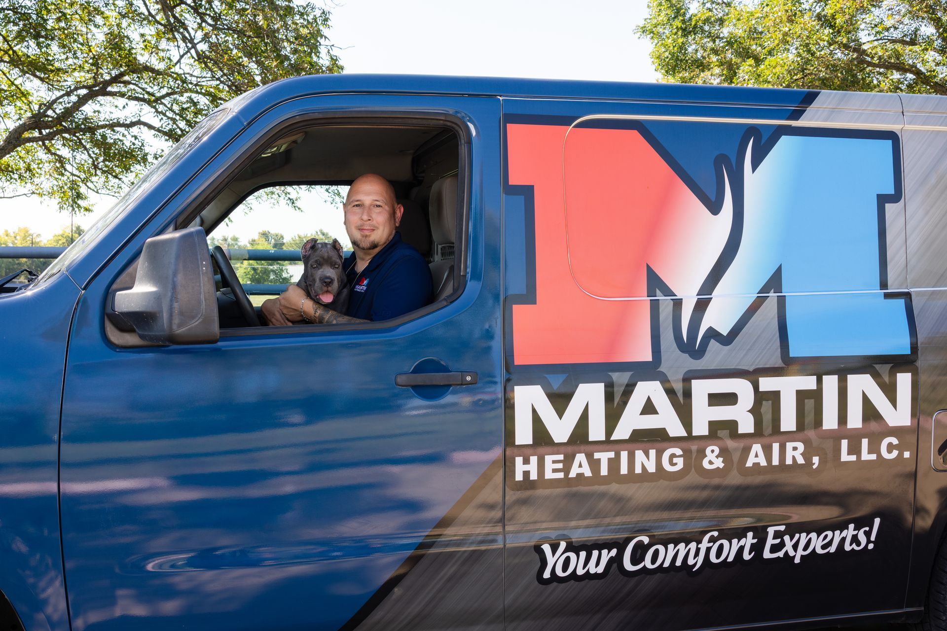 A living room with a brown couch and a gray chair.